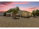 The backyard features gravel, siding, trees, and room for outdoor activities, perfect for relaxing and entertaining at 220 Palmer Park Ln, Davenport, FL 33897