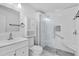 Modern bathroom featuring a glass-enclosed shower, white tile, and a built-in seat at 220 Palmer Park Ln, Davenport, FL 33897
