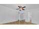 Spacious bedroom with wood floors, ceiling fan, and access to a bathroom at 220 Palmer Park Ln, Davenport, FL 33897