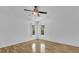 Bright bedroom with wood floors and a ceiling fan at 220 Palmer Park Ln, Davenport, FL 33897