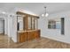 Bright dining room features a wood floor, built-in cabinets, and a window for natural light at 220 Palmer Park Ln, Davenport, FL 33897