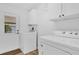 Laundry room with white washer and dryer, white cabinets, and outdoor access at 220 Palmer Park Ln, Davenport, FL 33897