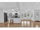 Spacious open-plan living area with hardwood floors, abundant natural light, and adjoining kitchen at 220 Palmer Park Ln, Davenport, FL 33897