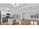 Bright open concept living area with hardwood floors, white walls and ceilings, and modern kitchen at 220 Palmer Park Ln, Davenport, FL 33897