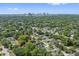 An aerial shot captures the city skyline in the distance, surrounded by lush trees and residential homes at 2306 Hargill Dr, Orlando, FL 32806