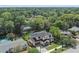 Aerial view of a modern home with mature trees, a lush yard, and a private backyard at 2306 Hargill Dr, Orlando, FL 32806