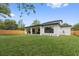 The backyard has lush green grass and a covered patio, perfect for outdoor entertaining at 2306 Hargill Dr, Orlando, FL 32806