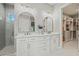 Bright, modern bathroom with double sinks, elegant lighting, shower and walk-in closet at 2306 Hargill Dr, Orlando, FL 32806