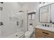 Modern bathroom with a marble tiled walk-in shower, sleek black fixtures, and a wooden vanity at 2306 Hargill Dr, Orlando, FL 32806
