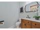 Modern bathroom with wood vanity, marble countertop, black fixtures, and contemporary decor at 2306 Hargill Dr, Orlando, FL 32806