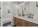 Bright bathroom featuring double vanity, modern fixtures, and black hexagon tile flooring at 2306 Hargill Dr, Orlando, FL 32806
