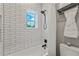 Bathtub and shower featuring white subway tile and matte black shower head and faucet at 2306 Hargill Dr, Orlando, FL 32806