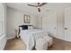Comfortable bedroom with hardwood floors, a ceiling fan, and minimalist decor, offering a serene space at 2306 Hargill Dr, Orlando, FL 32806