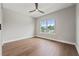 Bright bedroom with hardwood floors, a large window, and a ceiling fan at 2306 Hargill Dr, Orlando, FL 32806