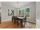 Dining room featuring a large window with backyard view, hardwood floors, and modern chandelier at 2306 Hargill Dr, Orlando, FL 32806