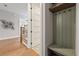 Hallway with wood floors, built-in bench nook, and a view to the stairs with iron railings at 2306 Hargill Dr, Orlando, FL 32806