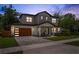 Charming two-story home featuring a wood garage door, large windows, and inviting front porch at 2306 Hargill Dr, Orlando, FL 32806