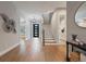 Inviting foyer with hardwood floors, staircase, and a modern front door at 2306 Hargill Dr, Orlando, FL 32806