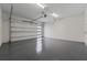 Spacious garage with epoxy flooring, white walls, and an insulated garage door at 2306 Hargill Dr, Orlando, FL 32806