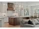 Open-concept kitchen and living area with a large island, modern lighting, and stainless appliances at 2306 Hargill Dr, Orlando, FL 32806