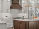 Beautiful kitchen featuring white cabinets, stainless steel appliances, and a wood range hood at 2306 Hargill Dr, Orlando, FL 32806