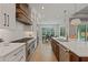 Open concept kitchen with a view to the dining area and backyard, featuring modern appliances at 2306 Hargill Dr, Orlando, FL 32806