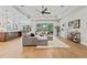 Open-concept living room with hardwood floors, tray ceilings, and a view into the kitchen at 2306 Hargill Dr, Orlando, FL 32806