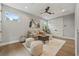 Cozy living room featuring light gray walls, windows, and a decorative ceiling fan at 2306 Hargill Dr, Orlando, FL 32806