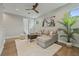 Comfortable living room with a plush rug, modern art, and a stylish ceiling fan at 2306 Hargill Dr, Orlando, FL 32806