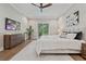 This main bedroom shows hardwood floors, sliding glass doors to backyard, TV and ceiling fan at 2306 Hargill Dr, Orlando, FL 32806