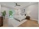 Bright main bedroom with hardwood floors, ceiling fan, and sliding glass doors leading to backyard patio at 2306 Hargill Dr, Orlando, FL 32806