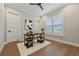 Bright home office featuring modern decor, sleek black desk, and a cozy white rug on hardwood floors at 2306 Hargill Dr, Orlando, FL 32806