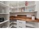 Bright walk-in pantry with custom wood countertops and ample white shelving for organized storage at 2306 Hargill Dr, Orlando, FL 32806