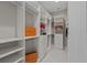 Walk-in closet featuring custom white shelving for clothing and storage organization at 2306 Hargill Dr, Orlando, FL 32806
