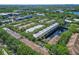 Community aerial view featuring a central pond, mature trees, and well-maintained residential buildings at 2329 Shadow View Cir # 2329, Maitland, FL 32751