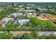 Overhead view of community buildings, a green baseball field, and lush trees at 2329 Shadow View Cir # 2329, Maitland, FL 32751