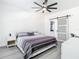 Bright bedroom with a ceiling fan, sliding door to closet, and sleek minimalist furniture at 2329 Shadow View Cir # 2329, Maitland, FL 32751
