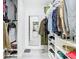 Open walk-in closet with neatly organized shelving, drawers, and a full-length mirror at 2329 Shadow View Cir # 2329, Maitland, FL 32751