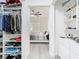 Open walk-in closet with neatly organized shelving, drawers, and a view to a bedroom at 2329 Shadow View Cir # 2329, Maitland, FL 32751