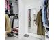 Open walk-in closet with neatly organized shelving, drawers, and a full-length mirror at 2329 Shadow View Cir # 2329, Maitland, FL 32751