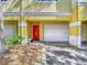 Attractive townhouse features a bright red front door, white garage door, and lush landscaping at 2329 Shadow View Cir # 2329, Maitland, FL 32751