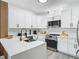 Bright kitchen with white cabinets, quartz countertops, stainless appliances, and modern fixtures at 2329 Shadow View Cir # 2329, Maitland, FL 32751