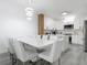 Modern kitchen featuring white cabinets, stainless steel appliances, island and a dining area with seating for eight at 2329 Shadow View Cir # 2329, Maitland, FL 32751