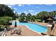 Community pool with lounge chairs and lush landscaping at 2329 Shadow View Cir # 2329, Maitland, FL 32751