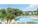 Large community pool with lounge chairs and lake views at 2329 Shadow View Cir # 2329, Maitland, FL 32751
