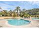 Community pool featuring lounge chairs, palm trees, and a bright blue swimming pool for residents at 2329 Shadow View Cir # 2329, Maitland, FL 32751