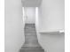 Hallway with stairs leading down into the basement and a bright white door at the far end at 2329 Shadow View Cir # 2329, Maitland, FL 32751