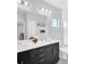 Elegant bathroom with double vanity, sleek black cabinets, and a glass-enclosed shower at 235 Villa Domani Cir, Davenport, FL 33896