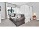 Cozy bedroom with neutral colors, soft lighting, and a large window overlooking the neighborhood at 235 Villa Domani Cir, Davenport, FL 33896
