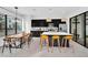 Bright, modern kitchen with sleek black cabinets, stainless steel appliances, island, and adjacent dining area at 235 Villa Domani Cir, Davenport, FL 33896